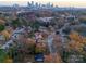 Aerial view showcasing a residential neighborhood with tree-lined streets and city skyline at 1330 Mulberry Ave, Charlotte, NC 28216