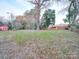 Spacious backyard with mature trees and a storage shed at 1330 Mulberry Ave, Charlotte, NC 28216