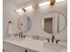 Double vanity bathroom with contemporary mirrors and matte gold fixtures at 1330 Mulberry Ave, Charlotte, NC 28216