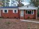 Charming brick ranch house with a well-maintained lawn at 1330 Mulberry Ave, Charlotte, NC 28216