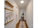 Bright hallway with wood floors and access to bedrooms and bathroom at 1330 Mulberry Ave, Charlotte, NC 28216