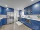 Modern kitchen with stainless steel appliances and blue cabinetry at 1330 Mulberry Ave, Charlotte, NC 28216