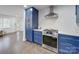 Modern kitchen with stainless steel appliances and blue cabinetry at 1330 Mulberry Ave, Charlotte, NC 28216