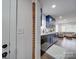 Modern kitchen with navy blue cabinets and exposed brick wall at 1330 Mulberry Ave, Charlotte, NC 28216