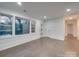 Hardwood floor living room with neutral walls and a view to backyard at 1330 Mulberry Ave, Charlotte, NC 28216