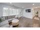 Spacious living room with hardwood floors and a gray sectional sofa at 1330 Mulberry Ave, Charlotte, NC 28216