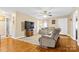 Living room with hardwood floors, comfy seating, and a large TV at 135 Rumple Hill Dr, Statesville, NC 28677