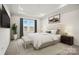 A serene main bedroom with a tray ceiling, neutral colors, and a window view at 13724 Roderick Dr # 168, Huntersville, NC 28078