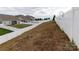 Sloped backyard with a white vinyl fence at 138 Gray Willow St, Mooresville, NC 28117