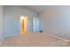 Bright bedroom featuring neutral carpet, light walls, and two doors to the bathroom and closet at 138 Gray Willow St, Mooresville, NC 28117