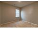 Bedroom with neutral walls and carpet and a large window offering an abundance of light at 138 Gray Willow St, Mooresville, NC 28117