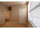 Bedroom with neutral walls and carpet, a large window, and doors for access and closet at 138 Gray Willow St, Mooresville, NC 28117