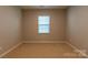 This cozy bedroom features neutral walls and carpet with natural light from the window at 138 Gray Willow St, Mooresville, NC 28117