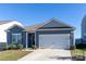 Ranch style home with gray siding, two car garage, and landscaped lawn at 138 Gray Willow St, Mooresville, NC 28117