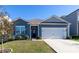 Charming single-story home with blue siding, attached two-car garage and well-manicured lawn at 138 Gray Willow St, Mooresville, NC 28117