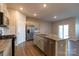 Well-lit kitchen featuring an island with sink, stainless steel dishwasher, and lots of cabinet space at 138 Gray Willow St, Mooresville, NC 28117