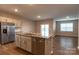 Kitchen island with granite countertop, sink, and dishwasher at 138 Gray Willow St, Mooresville, NC 28117