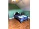 Small bedroom with a twin bed, chair, and green walls at 158 White Rd, Wadesboro, NC 28170