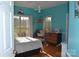 Bedroom with teal walls and wood floors at 158 White Rd, Wadesboro, NC 28170