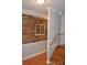 Wood staircase with a rustic reclaimed wood accent wall at 158 White Rd, Wadesboro, NC 28170