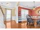 Bright dining room with coral walls, wood floors, and black chairs at 160 Millen Dr, Mooresville, NC 28115