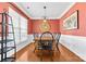 Bright dining room with coral walls, wood floors, and black chairs at 160 Millen Dr, Mooresville, NC 28115