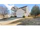 Two-story house with beige siding, a large garage, and landscaping at 160 Millen Dr, Mooresville, NC 28115