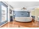 Living room with curved sofa, fireplace, and hardwood floors at 160 Millen Dr, Mooresville, NC 28115