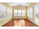 Sunroom with hardwood floors, multiple windows and yellow walls at 160 Millen Dr, Mooresville, NC 28115