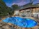 Inviting freeform pool with a stone patio and seating area at 19100 Mary Ardrey Cir, Cornelius, NC 28031