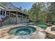 Luxury home with inviting pool and spa, surrounded by stone patio at 19100 Mary Ardrey Cir, Cornelius, NC 28031