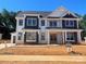 New two-story home featuring a covered entryway, double doors, and two-tone exterior at 2003 Kendall Dr # 5, Wesley Chapel, NC 28173