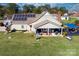 Aerial view showcases home's layout, backyard, and solar panels at 303 Knox St, Clover, SC 29710