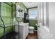 Bathroom with green walls, white vanity, and a toilet at 303 Knox St, Clover, SC 29710