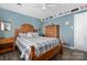 Bedroom with wood flooring, a wooden bed frame, and blue walls at 303 Knox St, Clover, SC 29710