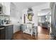 Bright kitchen features dark gray cabinets, wood floors, and a view into the living room at 303 Knox St, Clover, SC 29710