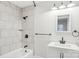 Modern bathroom with white vanity, tiled shower, and bathtub at 309 S Ransom St, Gastonia, NC 28052