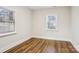 Well-lit bedroom with hardwood floors and two windows for natural light at 309 S Ransom St, Gastonia, NC 28052