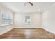 Empty bedroom boasts wood-look floors, neutral walls, and natural light from two windows at 309 S Ransom St, Gastonia, NC 28052