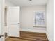 Small bedroom with wood floors and a window at 309 S Ransom St, Gastonia, NC 28052