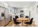 Bright eat-in kitchen featuring stainless steel appliances, gray cabinets, and a round dining table at 309 S Ransom St, Gastonia, NC 28052