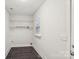 Bright laundry room with tile flooring and ample shelving at 309 S Ransom St, Gastonia, NC 28052