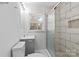 Bathroom featuring marble-look tiling in the shower, gray vanity, and a window bringing in natural light at 440 Providence Rd, Lancaster, SC 29720