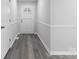 Entryway featuring gray wood flooring, white trim, and a decorative door at 440 Providence Rd, Lancaster, SC 29720