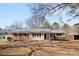 Charming one-story home with a metal roof, brick accents, and a well-maintained yard at 440 Providence Rd, Lancaster, SC 29720