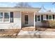 Close-up of the home's entry featuring a covered front porch with decorative columns and a brick foundation at 440 Providence Rd, Lancaster, SC 29720