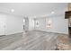 Spacious living room featuring a stone fireplace, neutral paint, and updated flooring at 440 Providence Rd, Lancaster, SC 29720