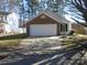 Brick ranch home with attached garage and landscaped yard at 8027 Bristle Ln, Charlotte, NC 28214