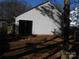 Rear exterior view of home with sliding glass doors and small patio at 8027 Bristle Ln, Charlotte, NC 28214