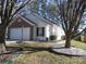 Brick and white sided home with attached garage at 8027 Bristle Ln, Charlotte, NC 28214